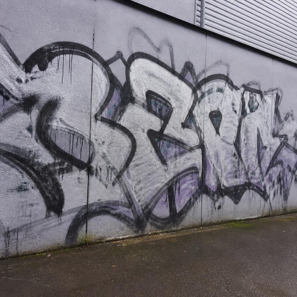 Graffiti on wall before removal