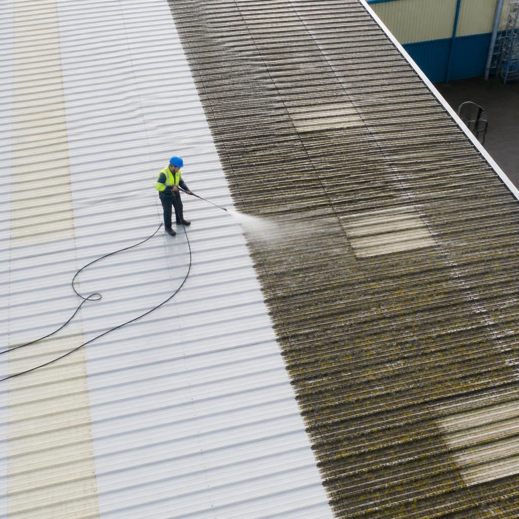 Aerial view of a roof during pressure washing process
